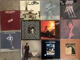 many different album covers on the wall of a room
