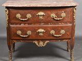 an antique chest of drawers with marble top and brass handles