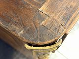 a close up of a wooden table with a clock on it
