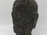 a close up of a statue of a head on a marble base
