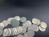 a pile of silver coins sitting on a table