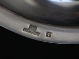 a silver pan with a lid on a black table