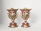 two vases are sitting on a white surface with a white background