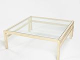 glass coffee table with wooden legs and a clear glass top