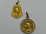 a gold medal and a gold medal with a woman ' s face on it