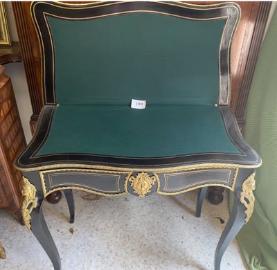 a black and gold chair with a green seat