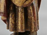 an image of a statue of a man with a hat and robe