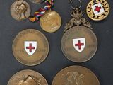 several medals and medals are displayed on a black surface