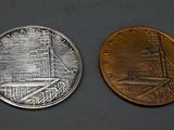 a close up of a coin with a picture of a ship on it