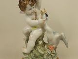 a figurine of a boy and a dog on a pedestal