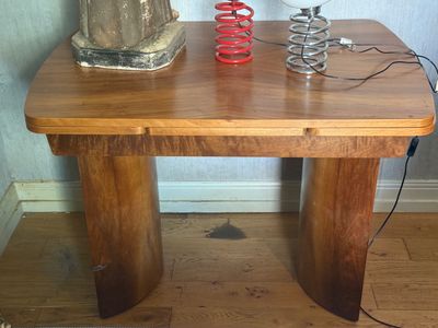 a wooden table with a lamp on top of it