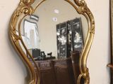a mirror that is sitting on a table in a room