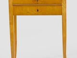 a small wooden table with a drawer on top of it