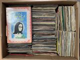 une boîte en carton remplie de livres et la photo d'une femme à lunettes