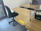 a desk with a chair and a computer on it