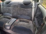 a picture of a car seat with a remote control in it