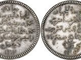 two silver coins with arabic writing on them