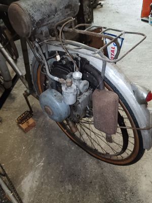 an old motorcycle that is parked in a garage
