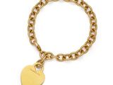a gold bracelet with a heart charm on it