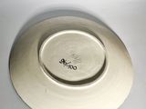 a white plate with a black design on it