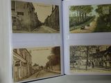 a hand holding a book open to a picture of a street
