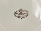 a close up of a white plate with a gold emblem on it