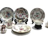many plates and cups that are sitting on a table