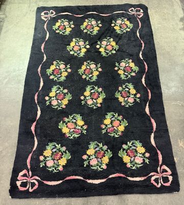 a black rug with a floral design on it on the floor