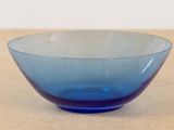 a blue glass bowl sitting on a table