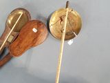 a person that is holding a wooden spoon and some chopsticks