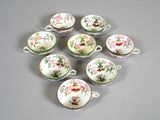 six cups and saucers with floral designs on them on a gray surface
