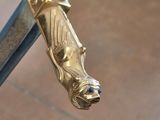 a close up of a gold sword with a blue handle