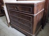 a chest of drawers with a marble top in a room