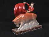 figurine of a man riding a bear with a flag on top of it