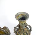 two vases sitting next to each other on a white surface