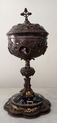 a silver bowl with a bird on it on a table