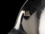 a close up of a silver spoon with a black background