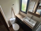 a bathroom with a toilet, sink, and mirror in it