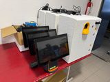a red table with a bunch of computers on top of it
