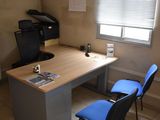 a desk with a chair and a printer on it
