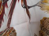 a close up of a scarf with a picture of a bird on it