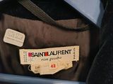 a coat hanging on a hanger with a label on it