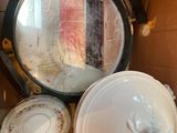 many plates and bowls in a box with a mirror