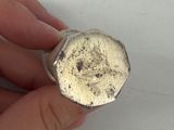 a person holding a piece of metal in their hand