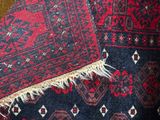 an image of a close up of a rug with a cat laying on it