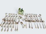 a lot of silver spoons and spoon spoons on a table