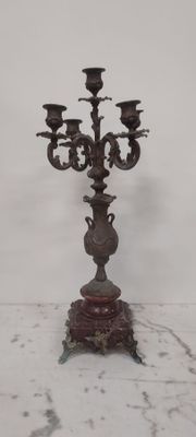 an antique candelabra with three candles on a marble base