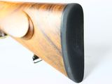 the rifle is made of wood and has a black handle