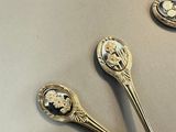 two spoons that are sitting on a table