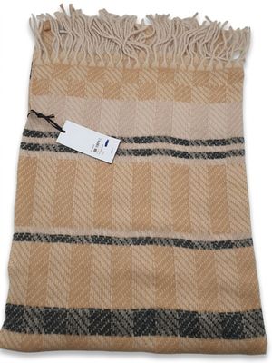 a tan and black blanket with a tag on it